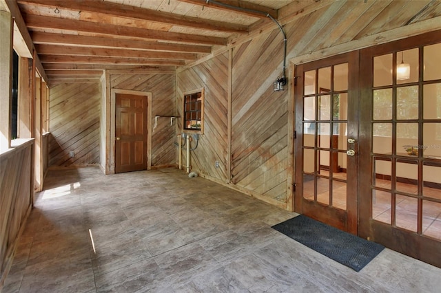 interior space with french doors, lofted ceiling with beams, and wooden ceiling