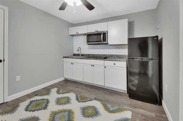 kitchen featuring black appliances, ceiling fan, white cabinetry, and tasteful backsplash