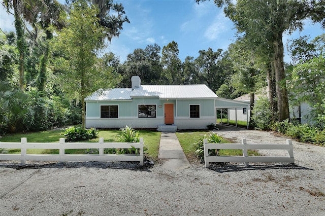 view of front of property with a front lawn and a carport