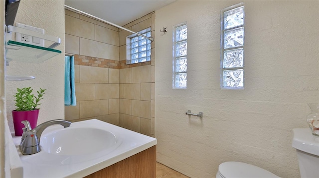 bathroom with tile patterned floors, vanity, and toilet