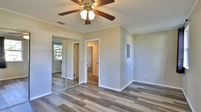 unfurnished bedroom featuring ceiling fan, hardwood / wood-style floors, and ornamental molding