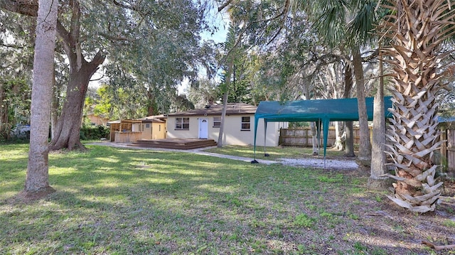 rear view of property with a yard and a wooden deck