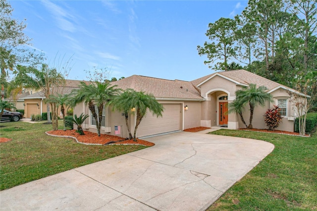 view of front of property featuring a front yard and a garage