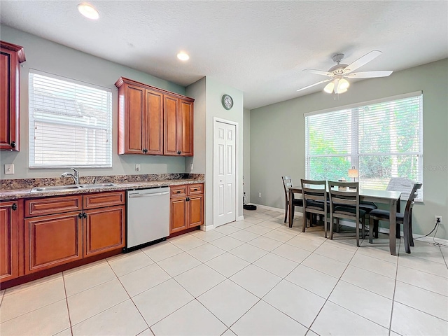 kitchen with ceiling fan, dishwasher, sink, a textured ceiling, and light tile patterned floors