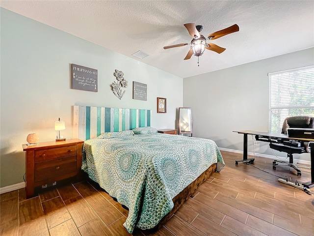 bedroom featuring a textured ceiling and ceiling fan