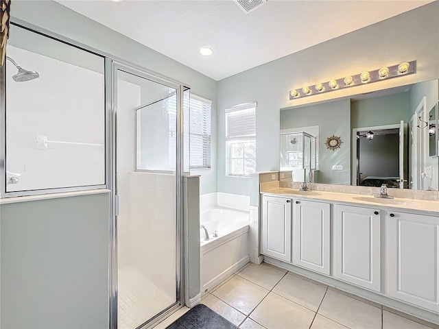 bathroom featuring tile patterned floors, vanity, and shower with separate bathtub