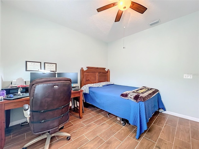 bedroom featuring a textured ceiling and ceiling fan