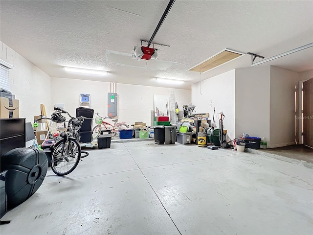 garage with a garage door opener and electric panel