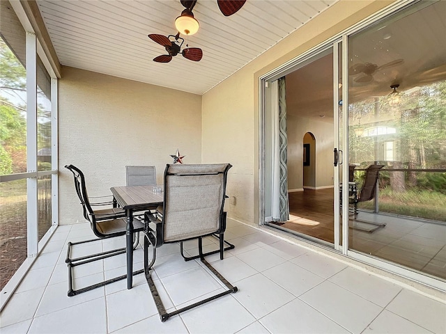 sunroom featuring ceiling fan and wood ceiling