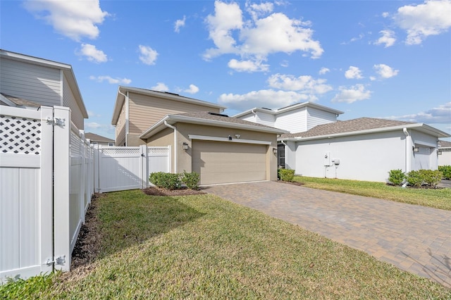 view of front facade with a garage and a front lawn