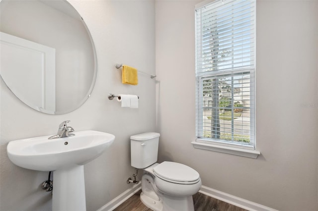 bathroom featuring hardwood / wood-style flooring, toilet, and sink