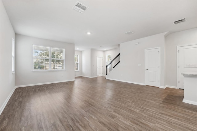 unfurnished living room with dark hardwood / wood-style flooring