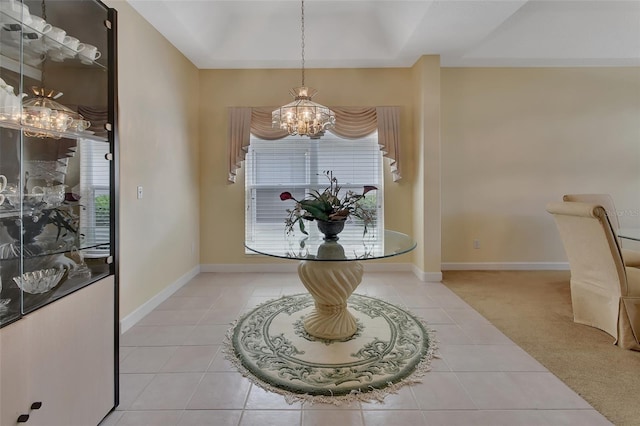 tiled foyer featuring a healthy amount of sunlight and an inviting chandelier