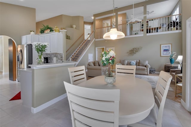 tiled dining room with ceiling fan