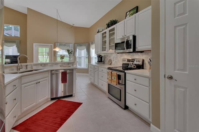 kitchen with white cabinets, pendant lighting, stainless steel appliances, and sink