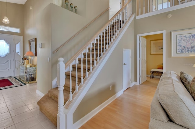 entryway with a high ceiling and light hardwood / wood-style flooring