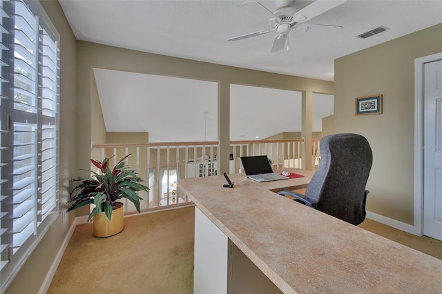 carpeted office space featuring ceiling fan