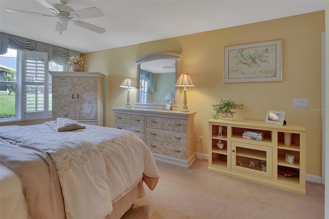 bedroom with ceiling fan and light colored carpet