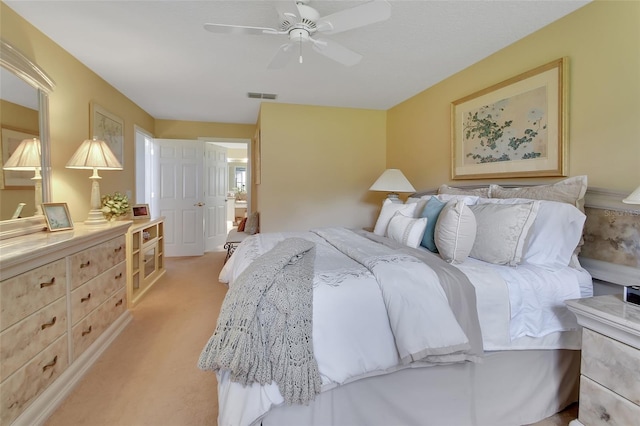 bedroom featuring ceiling fan and light colored carpet