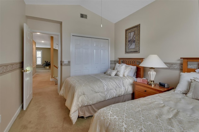 carpeted bedroom featuring lofted ceiling and a closet