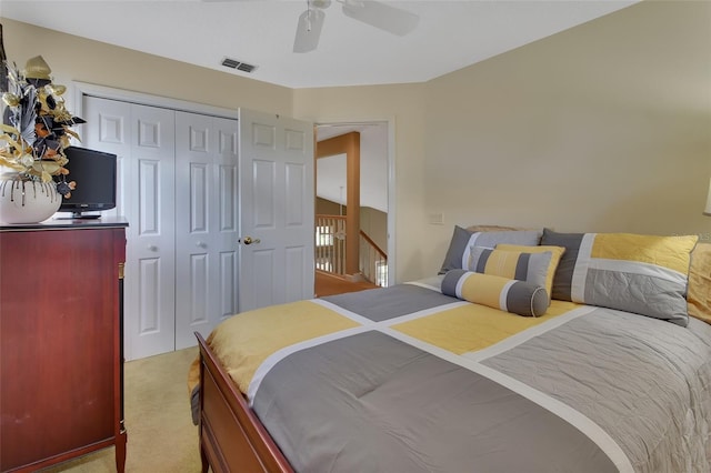 bedroom featuring a closet, ceiling fan, and light colored carpet