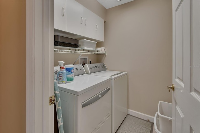 washroom with cabinets, light tile patterned flooring, and washer and dryer