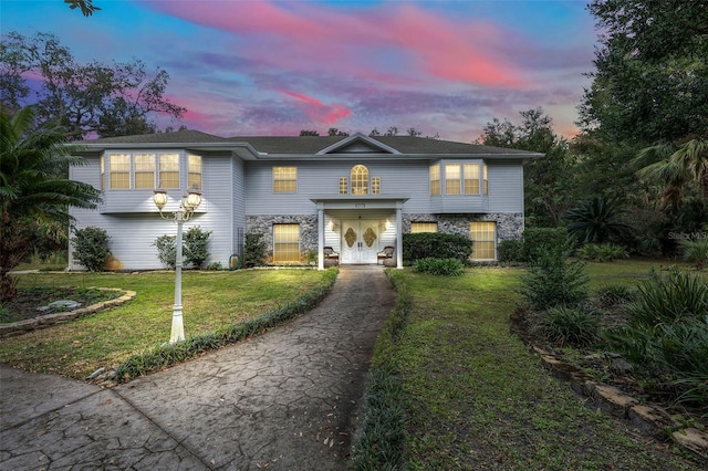 view of front of property with a lawn