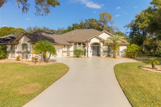 ranch-style home with a garage and a front lawn