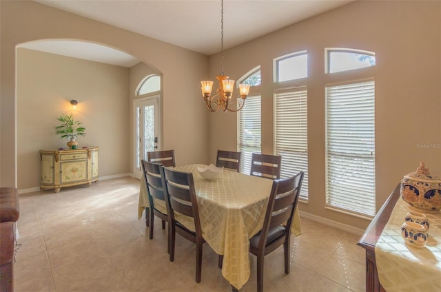 dining area featuring a notable chandelier and light tile patterned flooring