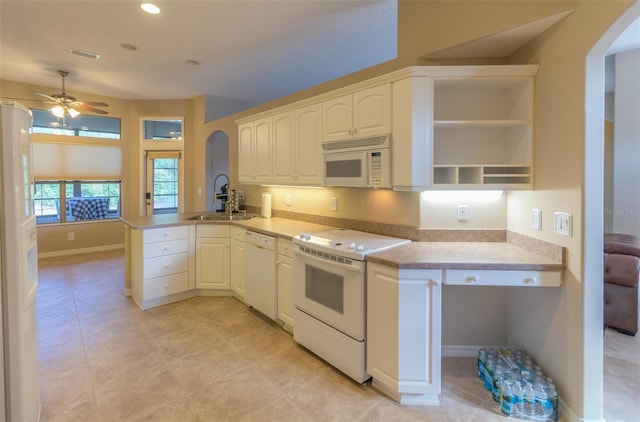 kitchen with kitchen peninsula, white appliances, ceiling fan, sink, and light tile patterned floors