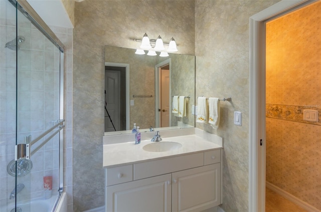 bathroom with vanity and bath / shower combo with glass door