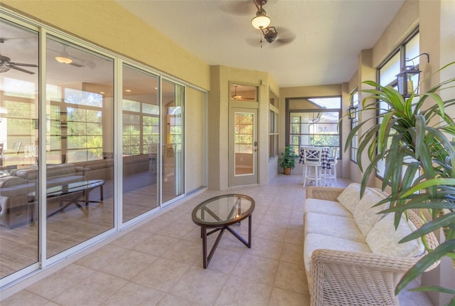 sunroom / solarium featuring ceiling fan and a wealth of natural light