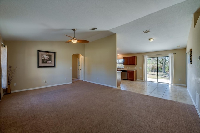 unfurnished living room featuring light carpet, ceiling fan, and lofted ceiling