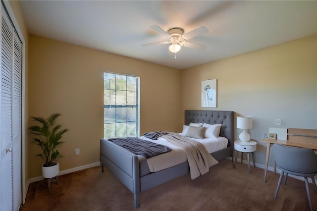 bedroom with a closet, dark carpet, and ceiling fan