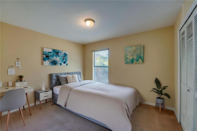 bedroom featuring light colored carpet and a closet