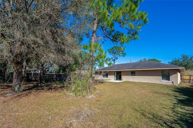 back of property with a lawn