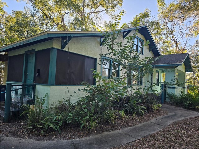 view of side of property with a sunroom