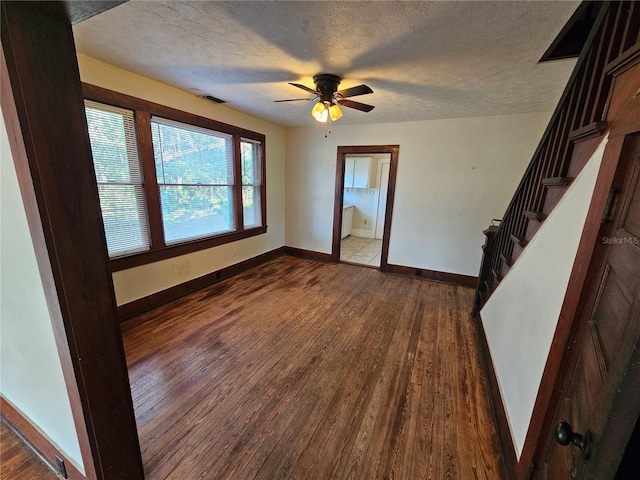 unfurnished room with ceiling fan, a textured ceiling, and hardwood / wood-style flooring