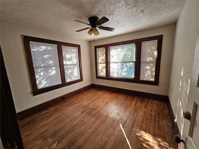 spare room featuring ceiling fan, wood-type flooring, and a textured ceiling