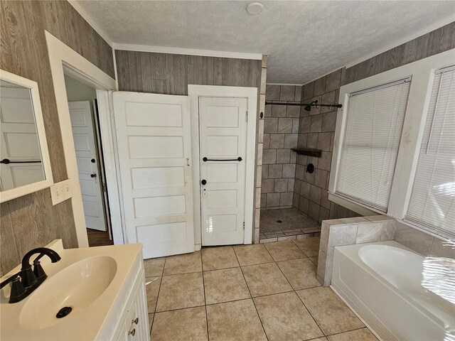 bathroom featuring tile patterned flooring, a textured ceiling, wooden walls, and independent shower and bath