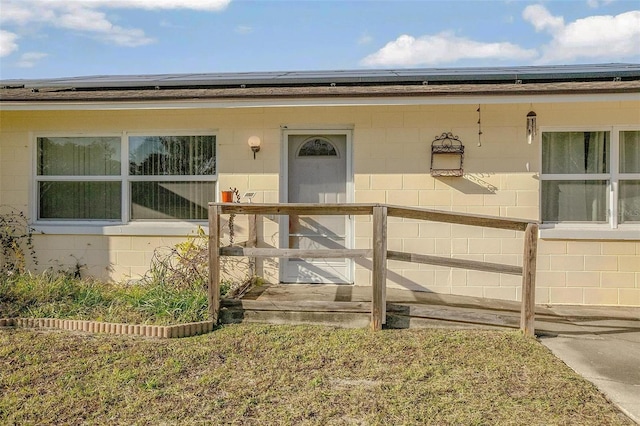 view of exterior entry with solar panels