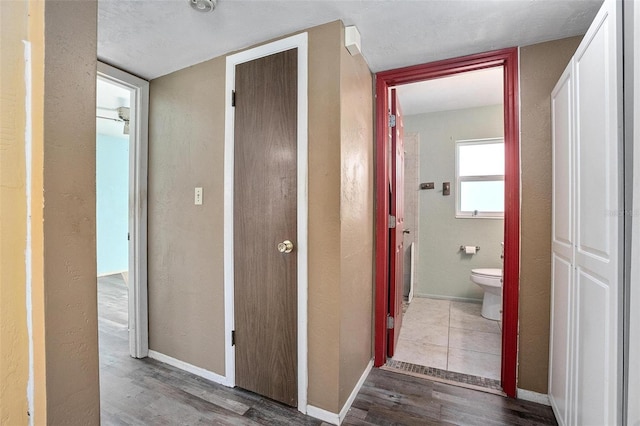 corridor with hardwood / wood-style flooring