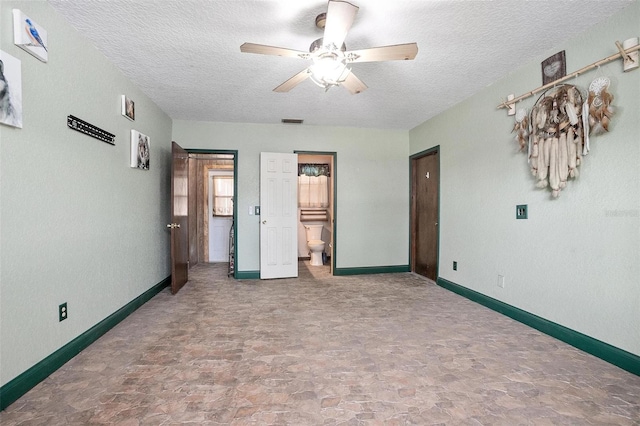 unfurnished bedroom featuring connected bathroom, ceiling fan, and a textured ceiling