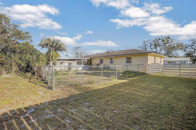 rear view of property featuring a yard