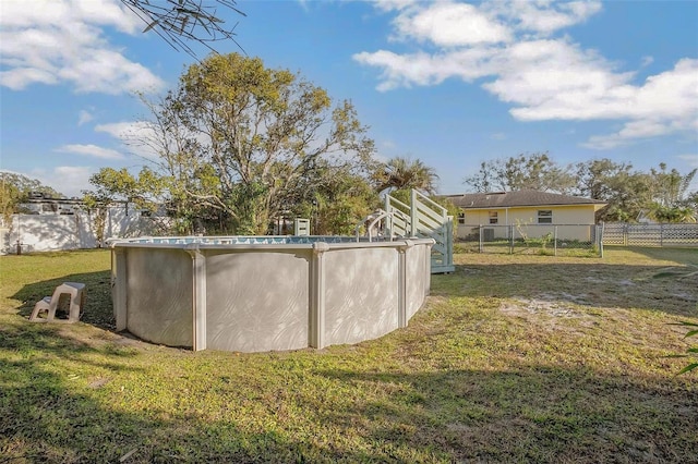 view of yard featuring a fenced in pool