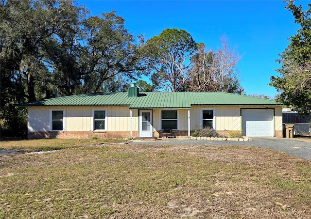 single story home with a front yard and a garage