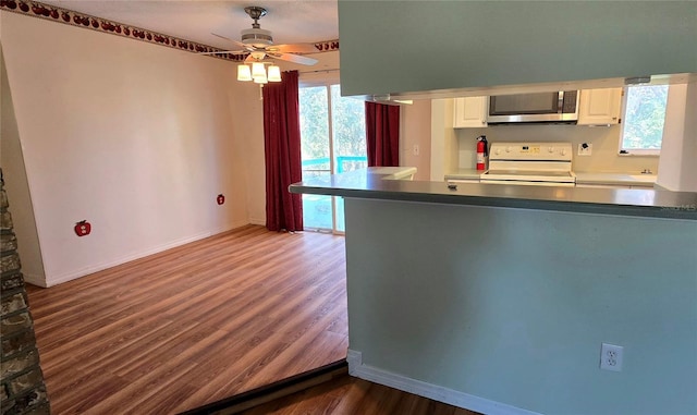 kitchen featuring white cabinetry, ceiling fan, dark hardwood / wood-style floors, white range with electric stovetop, and kitchen peninsula