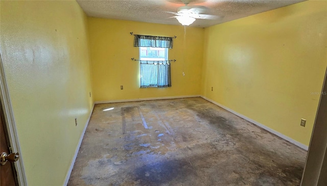 unfurnished room featuring a textured ceiling, ceiling fan, and concrete floors