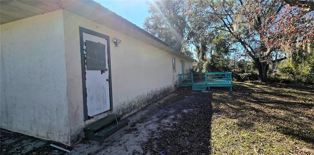 view of home's exterior featuring a wooden deck