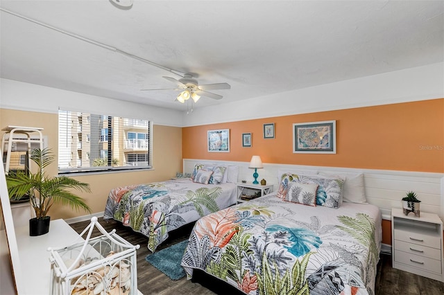 bedroom with ceiling fan and dark hardwood / wood-style flooring